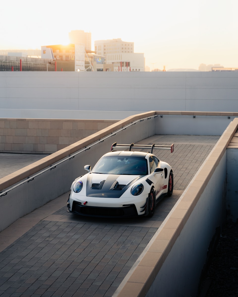 A white sports car on a ramp.
